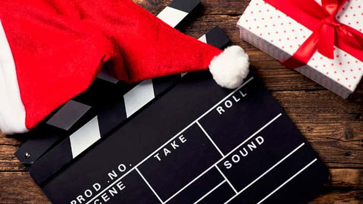 Christmas hat with film board cutout on wood background