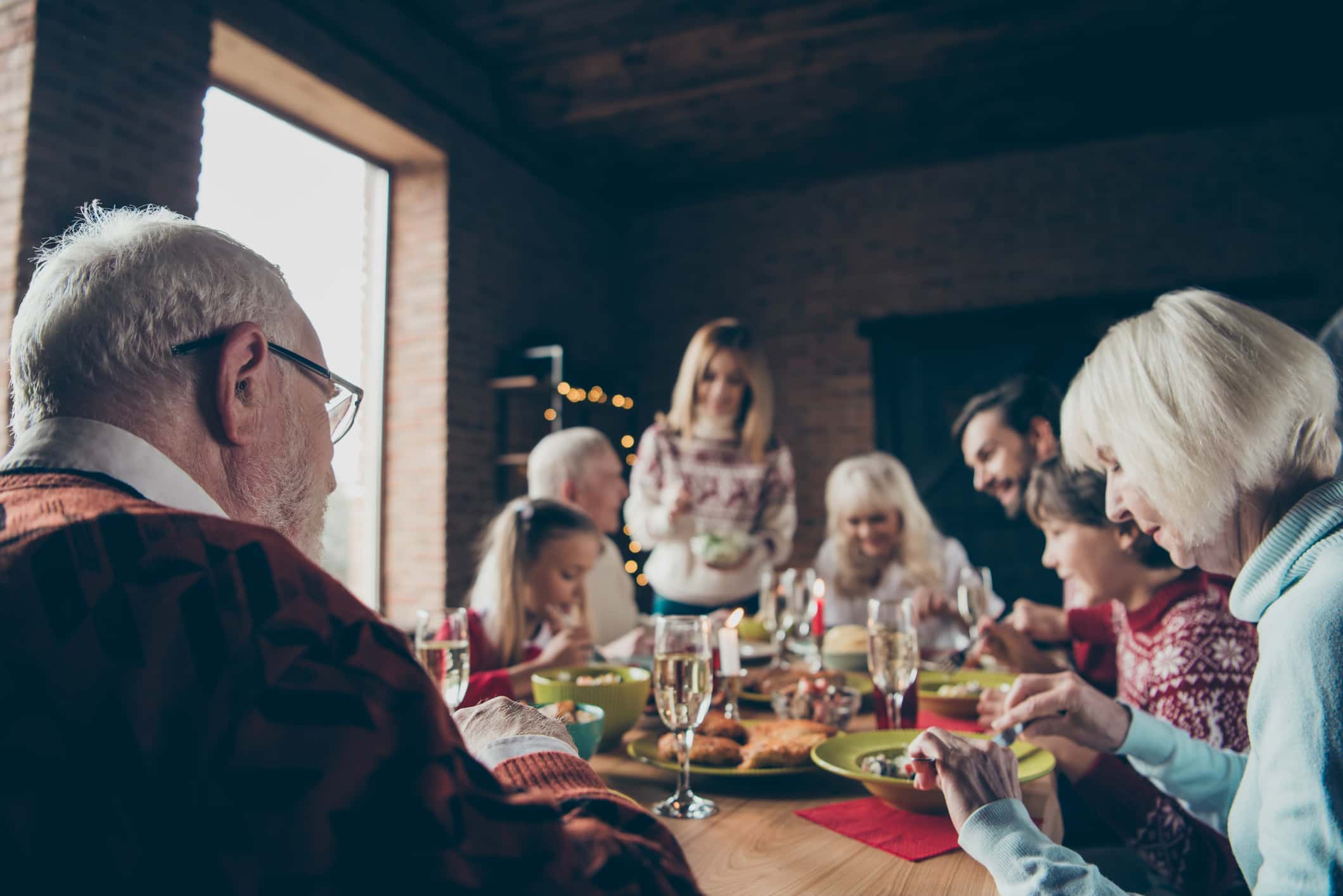 Noel evening family gathering, meeting. Grey-haired grandparents, grandchildren, daughter, son, brother, sister, relatives sitti