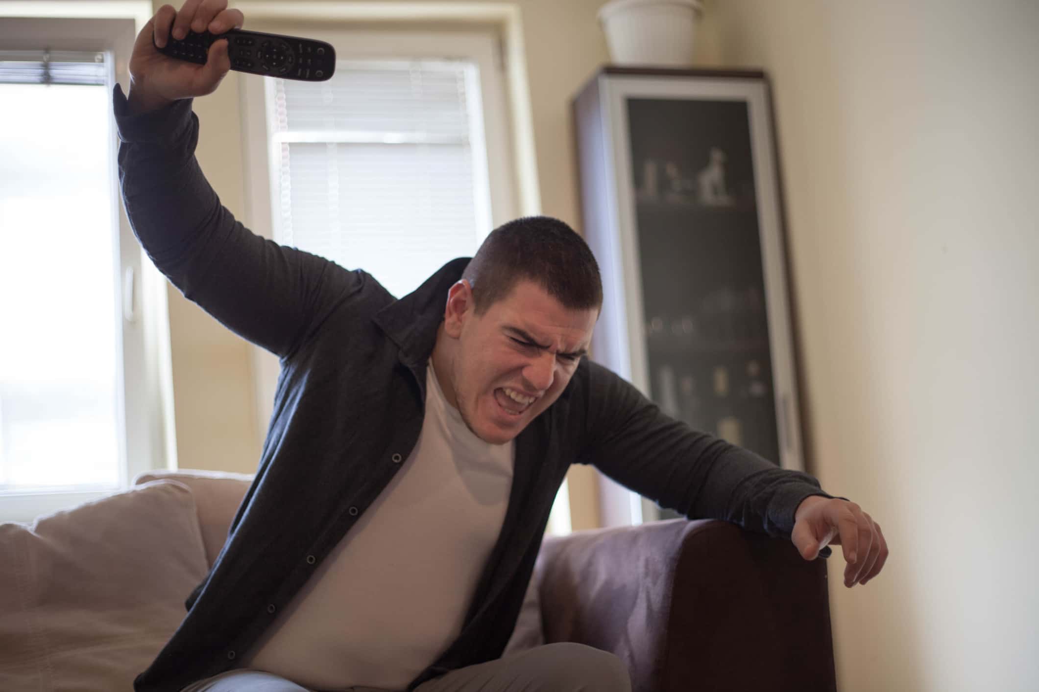 Angry man watching tv.