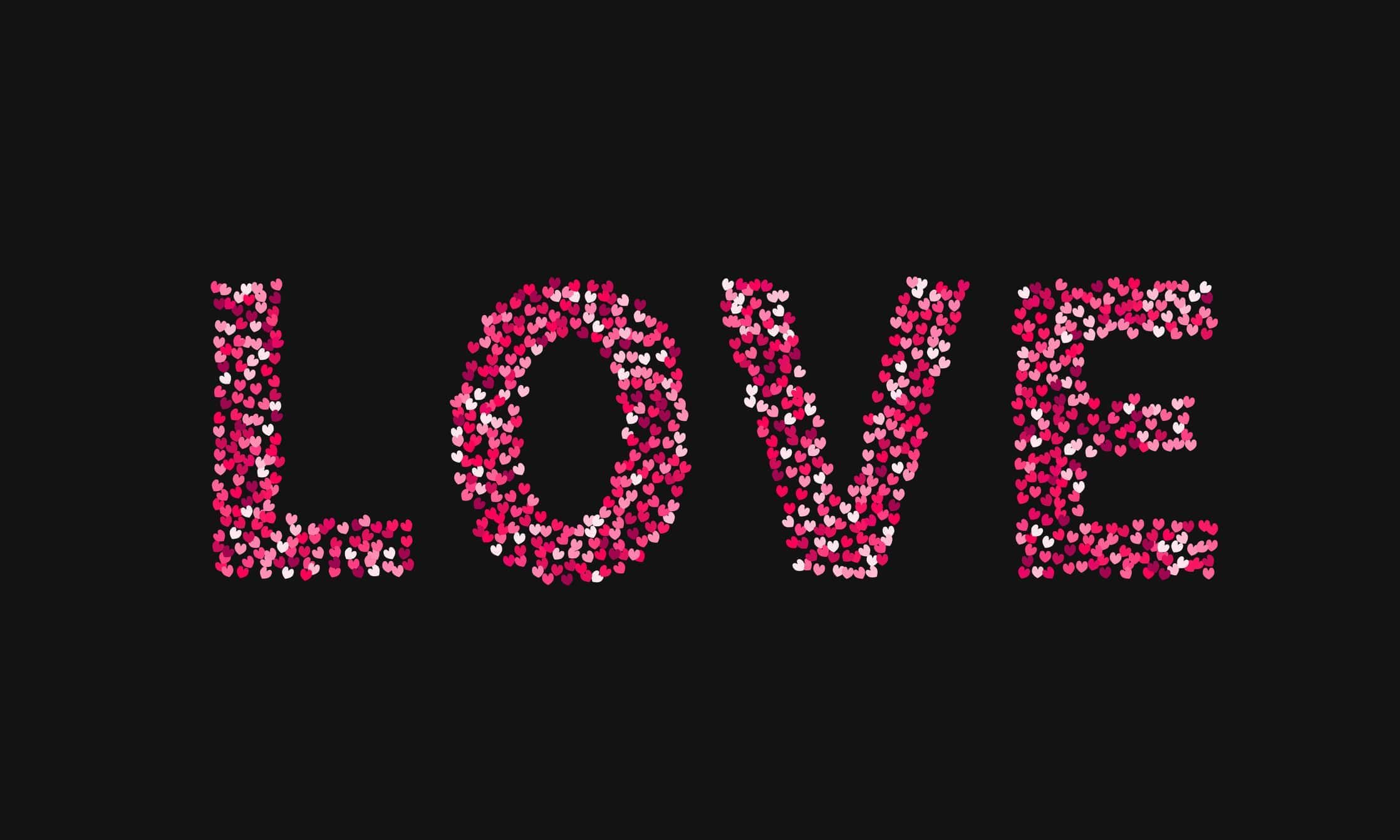 The word love made of little hearts shades of red and pink on black background. Valentine’s day typography poster.