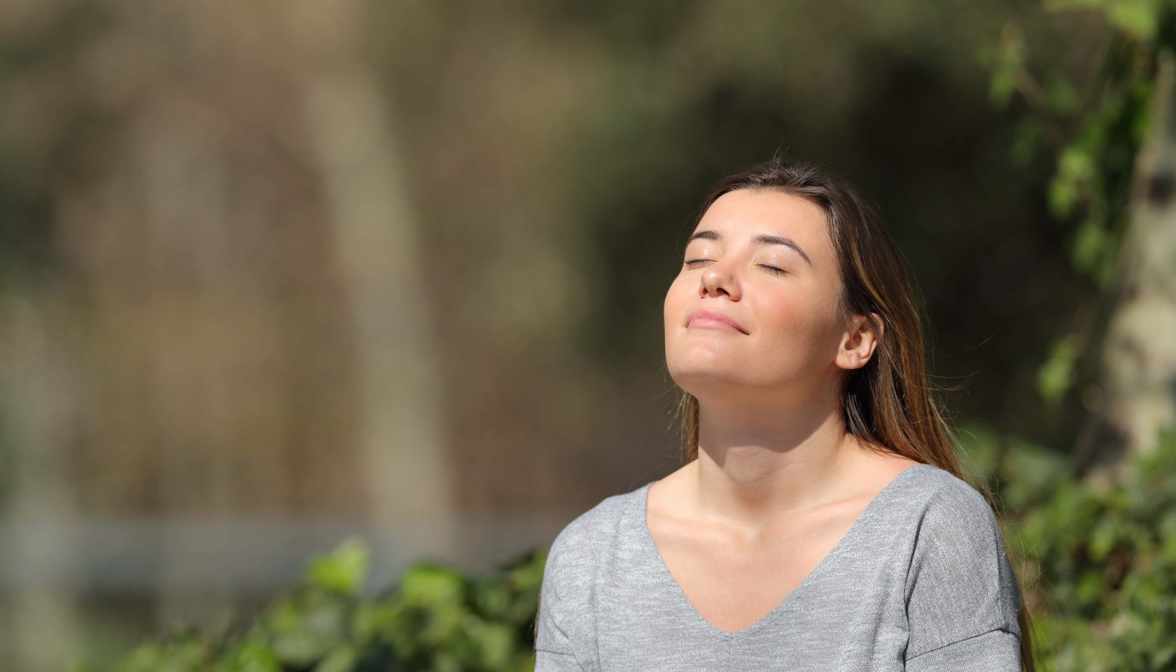 Relaxed girl breathing fresh air in a park a sunny day