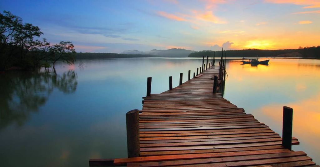 bridge over a sunset lake