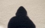Hooded person shadow outdoors in Missouri