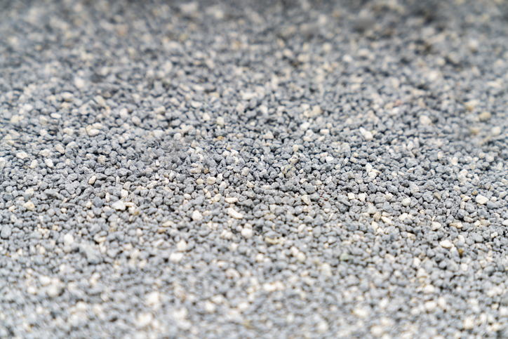 Cat litter granules close up. The texture of granular toilet filler. Cat litter in granules box. active carbon. texture pattern. Clean Cat litter in a litter tray. Background of white bentonite fresh