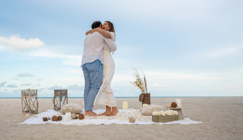 Loving couple at the beach celebrating their engagement!!