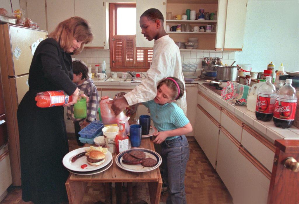 Dinnertime in the Jenisen household finds the kids gathering around to fill up their plates and head for the the living room for Dinner while watching the Simpsons. Robert Jones and Mikaela Jenisen work the table at the same time.(Photo by RITA REED/Sta