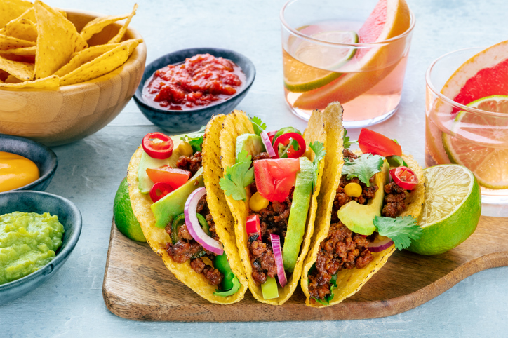 Tacos with meat and vegetables, with Paloma cocktails and nachos