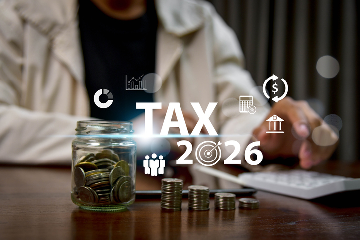 Businessman calculating tax with digital interface, concept of tax planning 2026, financial management, accounting, budget control, investment strategy and future business finance technology.
