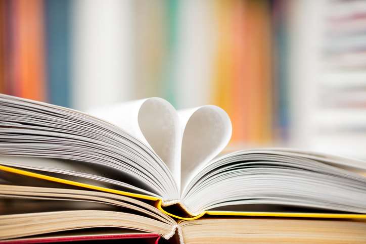 Love reading concept - open books with pages folded into a heart shape